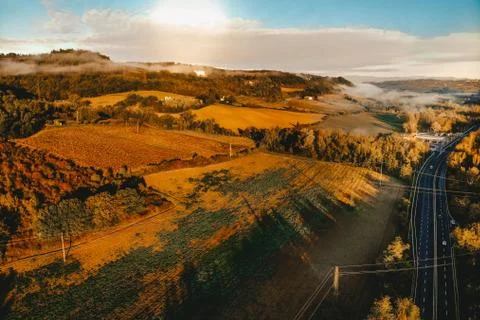 Landscape with a view from a height of a cloud forest along a sunny road Stock Photos