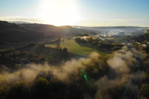 Landscape with a view from a height of a cloud forest along a sunny road Stock Photos