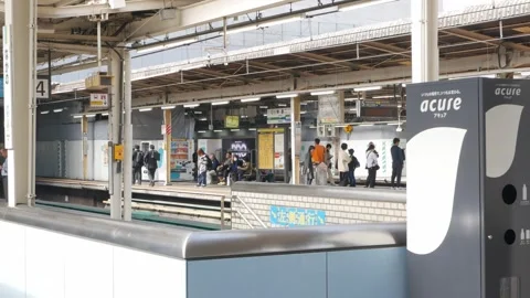Landscape view at JR platform train station with some passenger on the plat.. Vídeos de archivo 336472856
