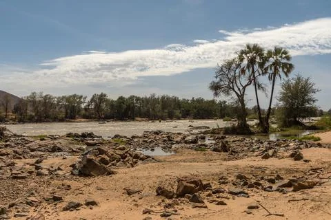 Landscape view of the Kunene River, the border river between Namibia-Angola Stock Photos