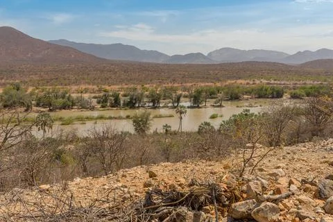 Landscape view of the Kunene River, the border river between Namibia-Angola Stock Photos