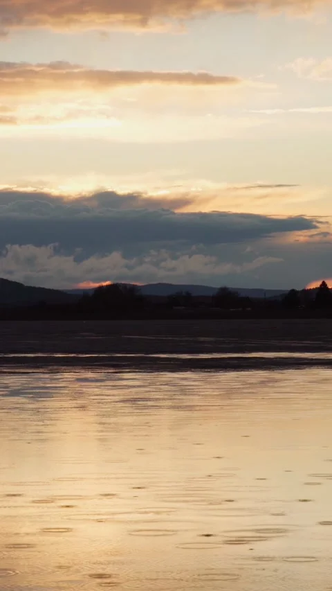 A landscape view of the lake, where it rains a little at sunset. Stock Footage 273672774
