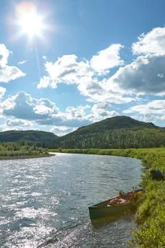 Landscape view of a large river with a canoe Stock-Fotos