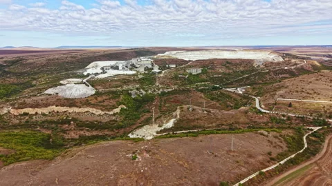 Landscape view of a mining site located outside a town with machinery and Stock Footage 345455702