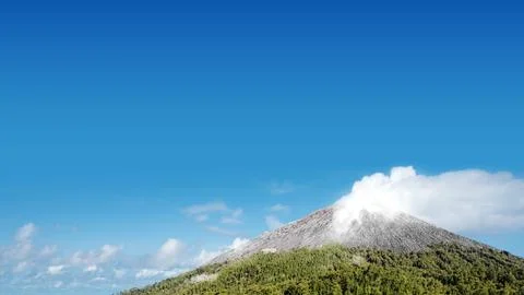 Landscape view of mountain with cloudscapes against blue sky background. Na.. Stock Photos