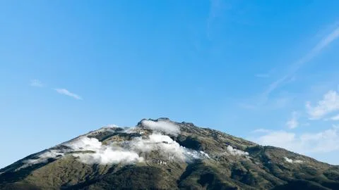 Landscape view of mountain with cloudscapes against blue sky background. Na.. Stock Photos