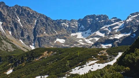 Landscape view of mountain range peaks party covered with snow Stock Footage 121903495