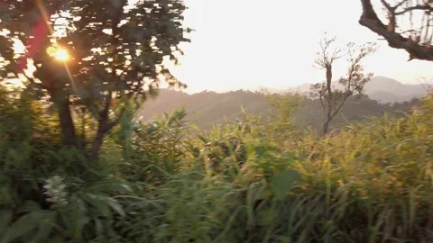 Landscape view on moving car of sunset view of mountain range with some clo.. Stock Footage 223319210