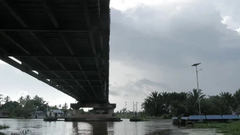 Landscape view, pile of coconut lumber under the bridge of Martapura ruver Stock Footage 133446464