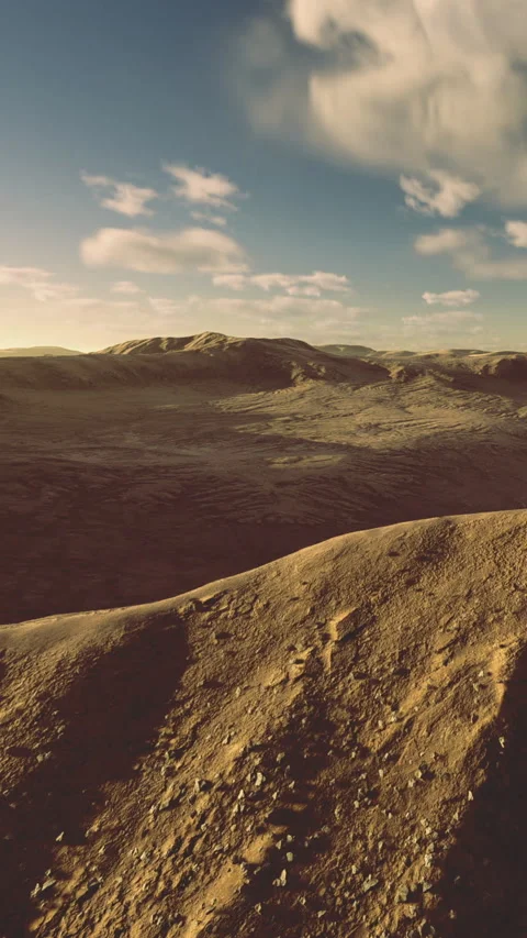 Landscape view of rocky terrain under blue sky with distant hills and clouds Stock Footage 336166326