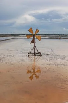 Landscape view of salt fields and windmill in Thailand. Stock-Fotos