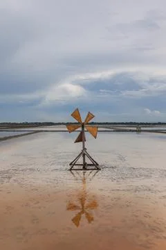 Landscape view of salt fields and windmill in Thailand. Stock-Fotos