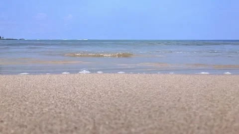 Landscape view of sea waves on the beach during a sunny day Stock Footage 259636845