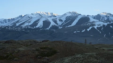 Landscape view: snow-capped altai mountain peaks with barren hills on foothills Stock Footage 103107394