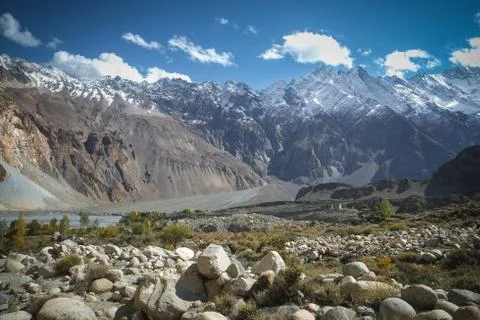 Landscape view of snow capped mountains and meadow in Passu. Stock Photos
