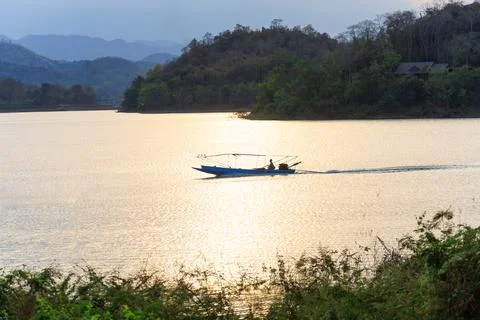 Landscape view of sunset and long-tailed boats carrying tourists running in a Stock Photos
