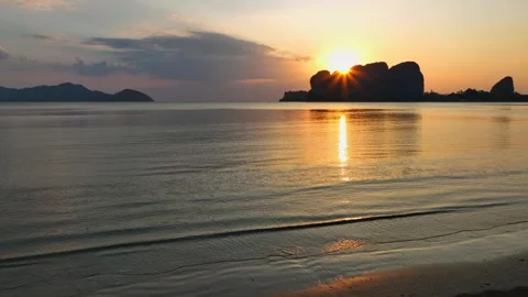 Landscape view with Sunset as breaking through the dark clouds over ocean sea Stock Footage 311796710