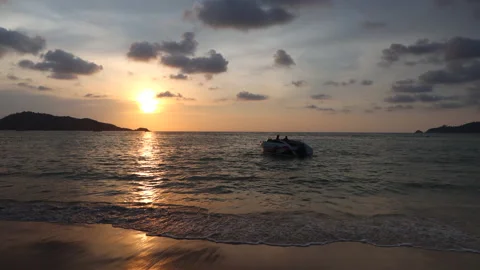 Landscape view of sunset in the sea on beach. A boat is sailing on the sea 스톡 동영상 145456952