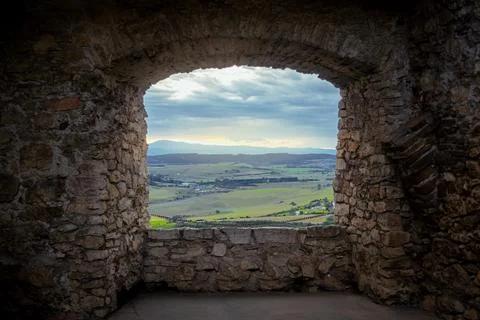 Landscape view through the window of a medieval castle. Stock Photos
