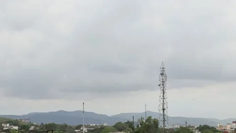 Landscape views with telephone tower, clouds passing by and birds flying. Stock Footage 131654646