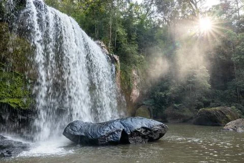 The landscape of a waterfall during sunset. Stock Photos
