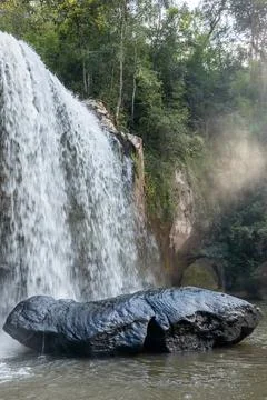 The landscape of a waterfall during sunset. Stock Photos