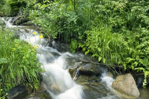 Landscape with waterfall in the mountains Stock Photos