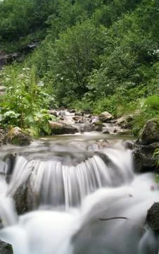 Landscape with waterfall in the mountains Stock Photos