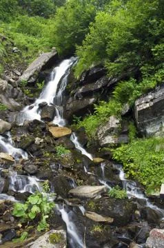Landscape with waterfall in the mountains Stock Photos