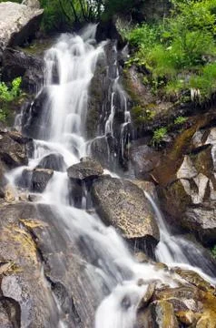 Landscape with waterfall in the mountains Stock Photos