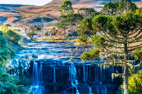 Landscape with waterfall, pine trees and field in the mountain range of Santa Stock Photos
