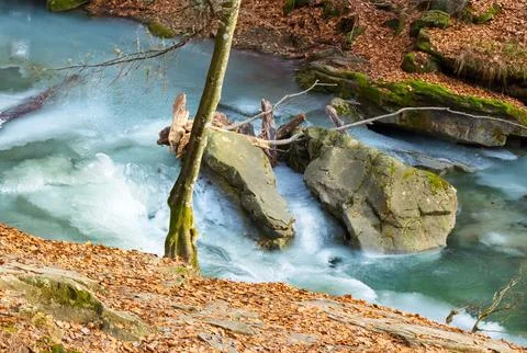 Landscape with waterfall in winter Stock Photos