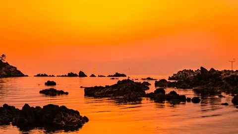 A landscape where the red sun rises over the sea. Time lapse. Zoom out Stock Footage 145739990