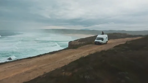 Landscape of wild ocean coast with waves and a van shot by drone Stock Footage 203598212