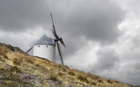 Landscape with windmill with cloudy sky in the town of Consuegra in Toledo. Stock Photos