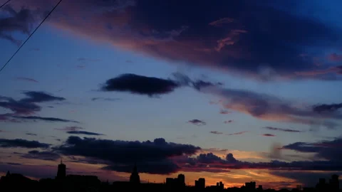 Landscape from window, sunset clouds, city silhouette bright clouds Video stock 295455755
