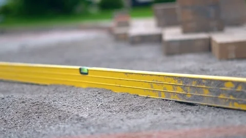 Landscape worker leveling driveway for brick placement Video stock 78067515