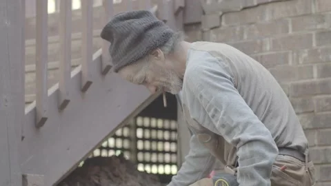 Landscaper is laying stone in backyard Video stock 146196708