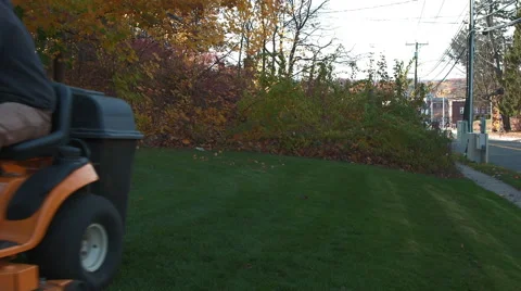 Landscaper picks up last few leaves with tractor Stock Footage 44782812