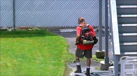 Landscaper uses power leaf blower Stock Footage 40208392