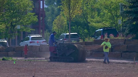 Landscapers Use Mechanical Installer To Lay Grass Sod Stock Footage 208672984