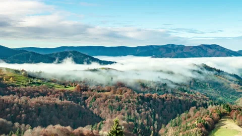 Landscapes of green hills under a layer of white and fluffy clouds Stock Footage 146448071