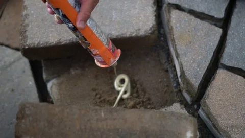 Landscaping brick glue & placement in slow motion Stock Footage