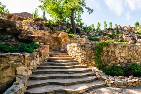 Landscaping. Decorative stone steps down the hill Stock Photos