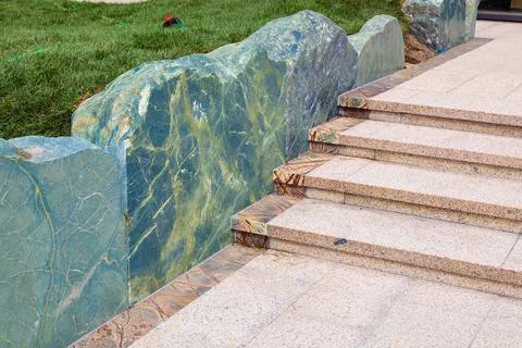 Landscaping, pathway edging with steps and diabase stone boulders. Stock Photos