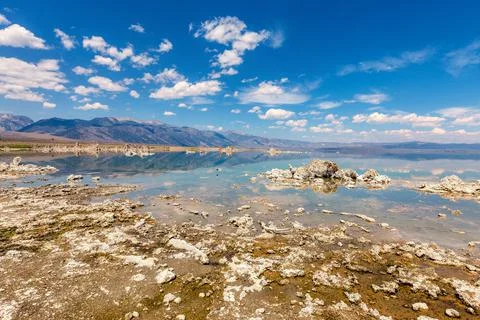 Landscaping view of Mono Lake, mountains and sky reflecting in water Stock Photos