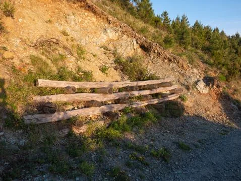 Landslide prevention:  structure made with trunks to consolidate the soil Stock Photos