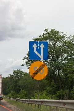 Lane Split And End Of Speed Limit Road Signs Stock Photos