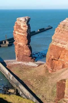 Lange Anna sea stack and tall red dramatic cliffs of Heligoland island on a nice Stock Photos