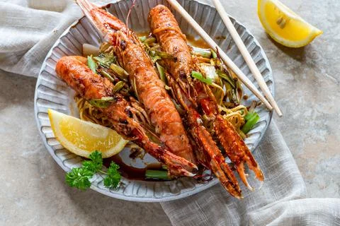 Langoustines with crispy fried egg noodles Stock Photos